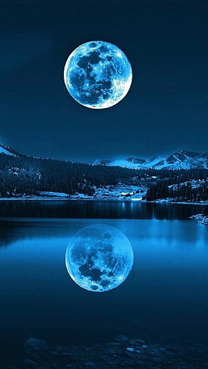 Glowing Blue Full Moon Reflected in a Serene Mountain Lake at Night HD phone wallpaper