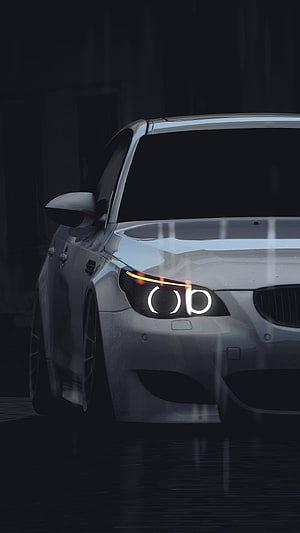BMW M5 E60 Front Headlight Detail in Dark Garage Setting HD phone wallpaper