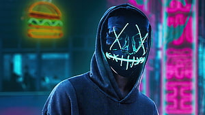 Person in Hoodie Wearing Glowing Neon Mask in Cyberpunk City HD wallpaper