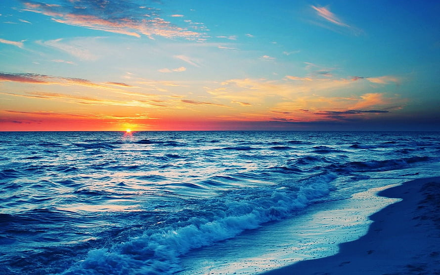 Vibrant Ocean Sunset Over Calm Waves And Sandy Shoreline HD wallpaper