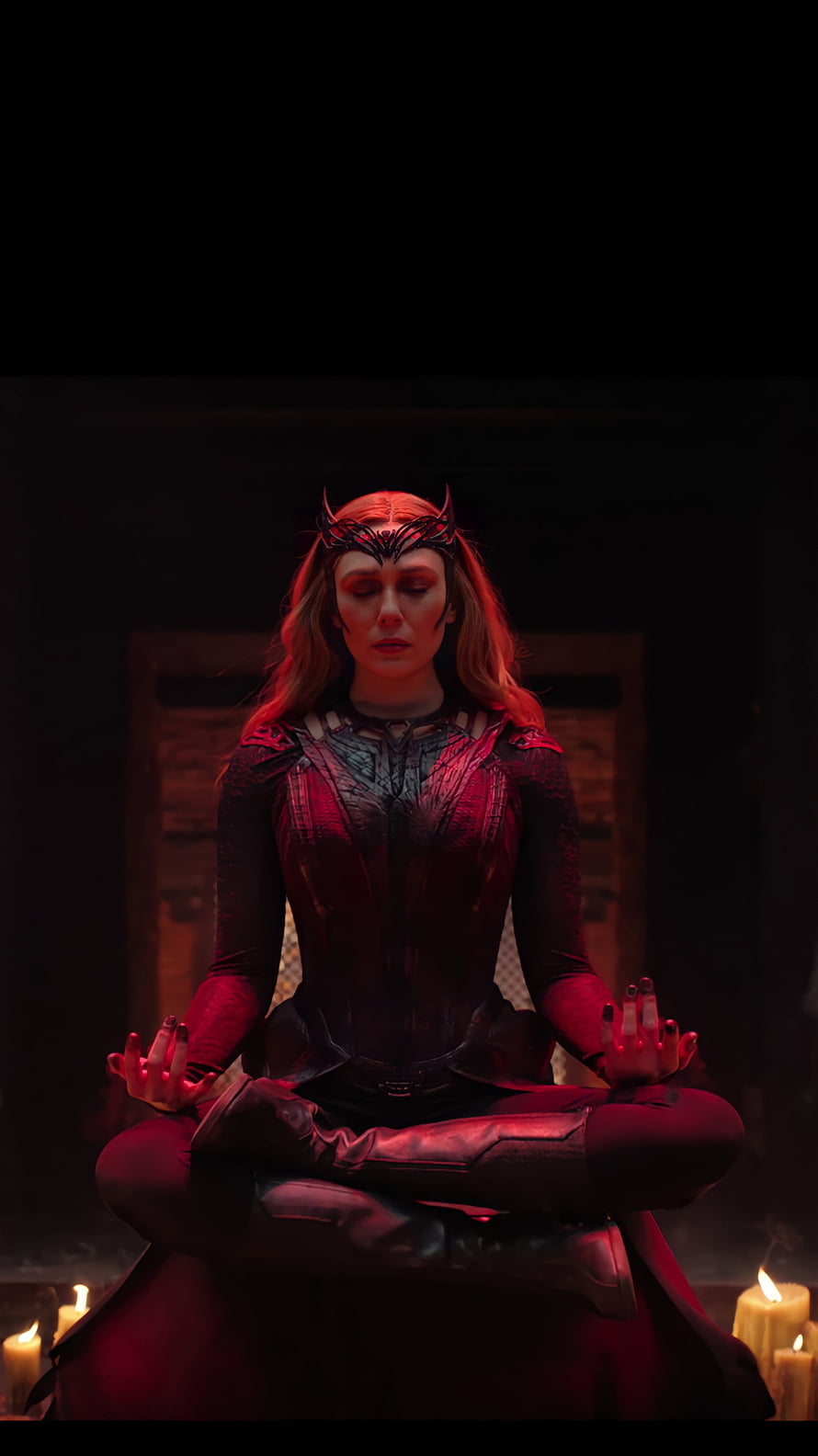 Scarlet Witch Meditating in Dark Chamber with Candles and Red Lighting HD phone wallpaper