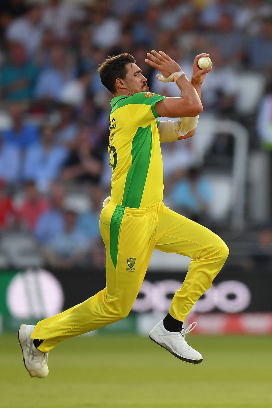 Mitchell Starc in Action During Cricket Match in Yellow and Green Uniform HD phone wallpaper