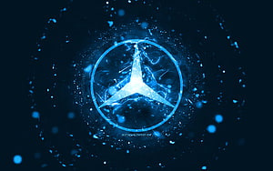 Glowing Mercedes-Benz emblem with electric blue energy and particle effects on a dark background HD wallpaper