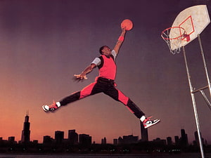 Michael Jordan Mid-Air Dunk Over Chicago Skyline at Sunset HD wallpaper