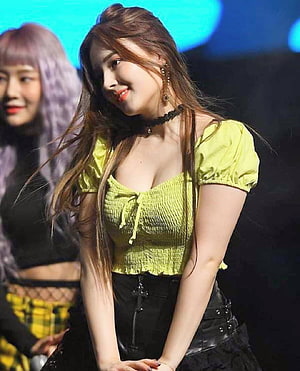 Nancy from Momoland in a lime green smocked top and black leather skirt on stage HD phone wallpaper