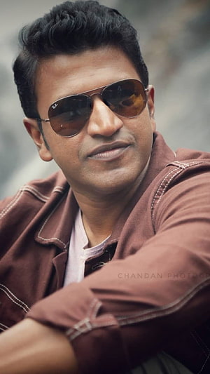 Punith Rajkumar Portrait Wearing Aviator Sunglasses and Brown Jacket HD phone wallpaper