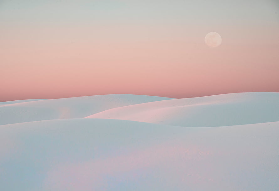 Pastel White Desert Dunes Under a Soft Pink Sky with a Faint Moon HD wallpaper