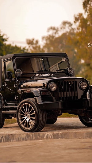 Black Mahindra Thar SUV with Custom Alloy Wheels Parked on a Concrete Surface HD phone wallpaper