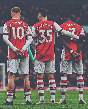 Arsenal Players Smith Rowe Martinelli and Saka Standing Together on the Pitch HD phone wallpaper