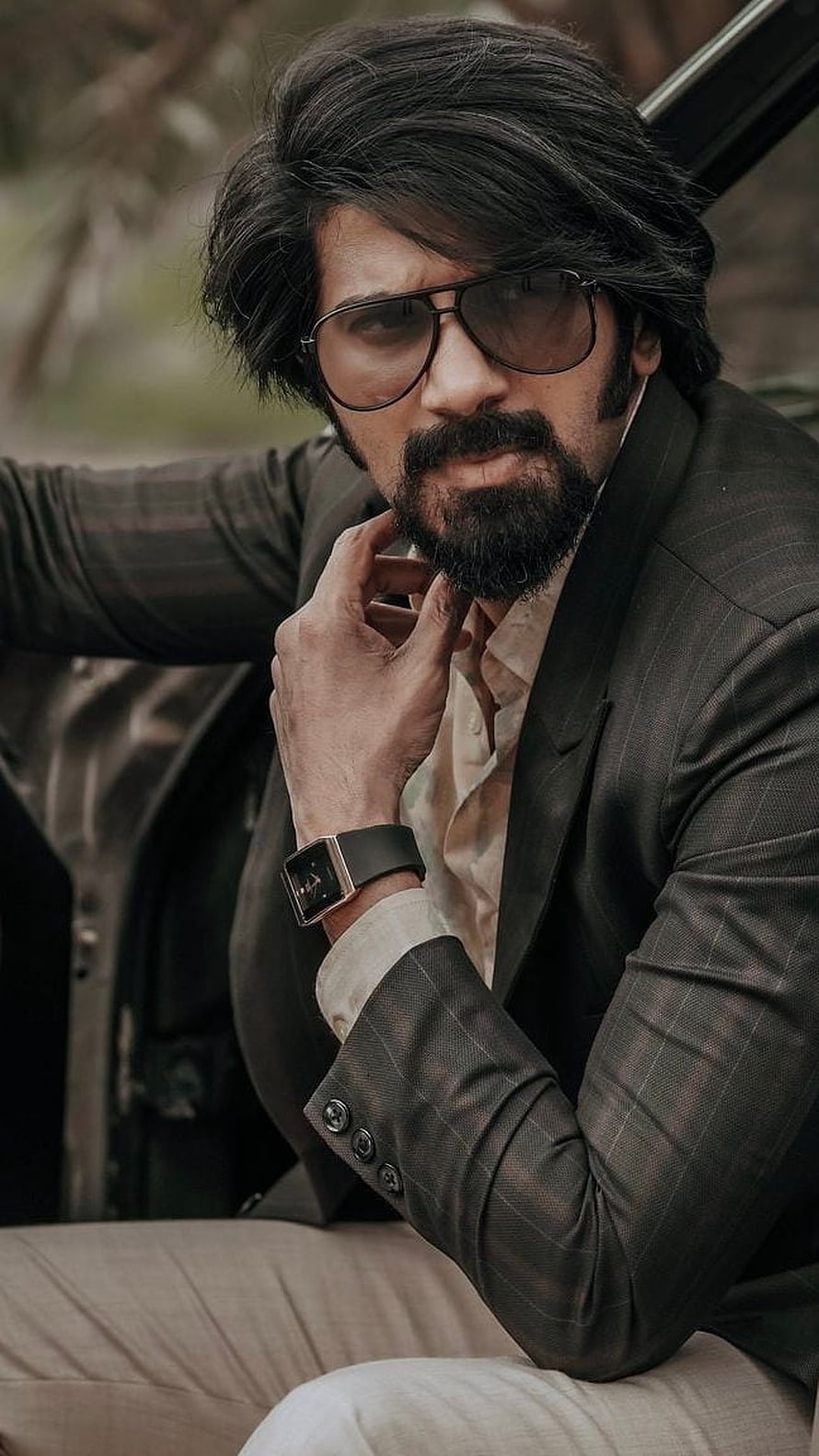 Dulquer Salmaan as Kurup in a dark suit and aviator sunglasses HD phone wallpaper