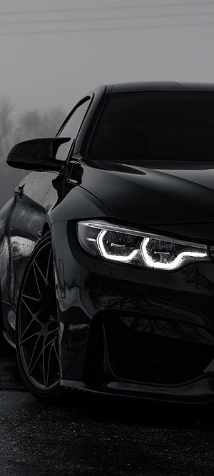 Black BMW M4 F82 Front Headlight and Wheel Close-Up in Monochrome HD phone wallpaper