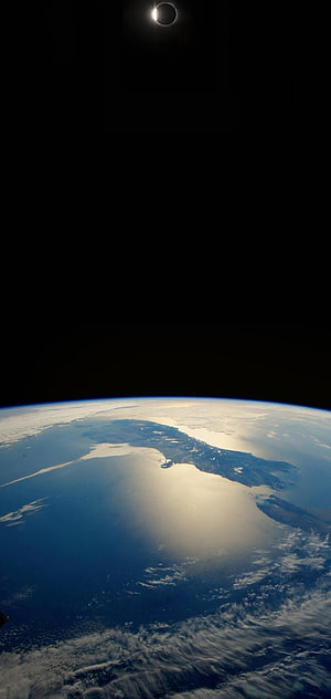 Total Solar Eclipse Over Earth's Curved Horizon From Space HD phone wallpaper