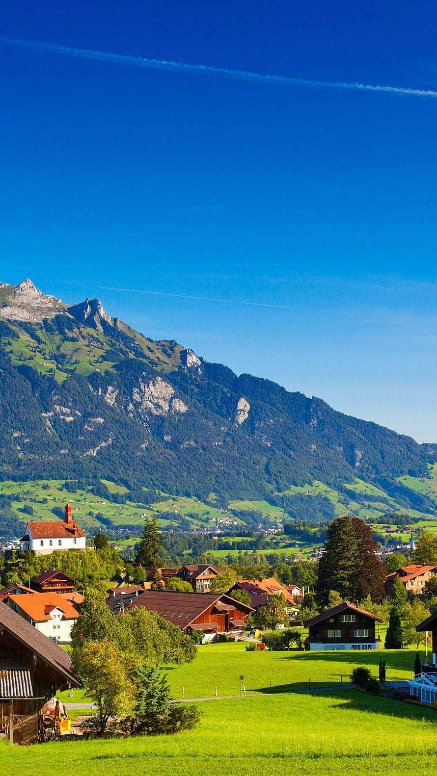 Swiss Alpine Village with Traditional Chalets and Mountain Backdrop HD phone wallpaper