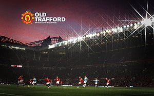 Manchester United Players in Action at Old Trafford Stadium Under Night Floodlights HD wallpaper