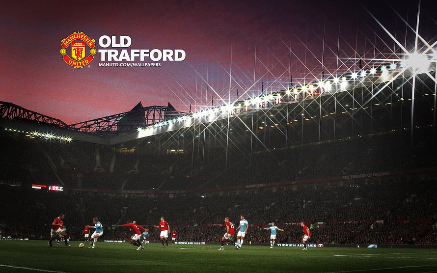 Manchester United Players in Action at Old Trafford Stadium Under Night Floodlights HD wallpaper