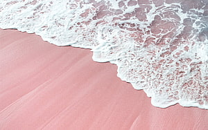 Pink Sand Beach with White Ocean Foam and Gentle Waves HD wallpaper