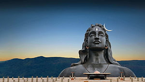 Shiva Statue at Isha Foundation with Crescent Moon and Mountain Backdrop HD wallpaper