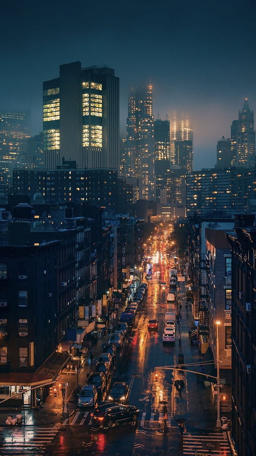 Moody Nighttime Cityscape with Wet Streets and Glowing Skyscrapers HD phone wallpaper