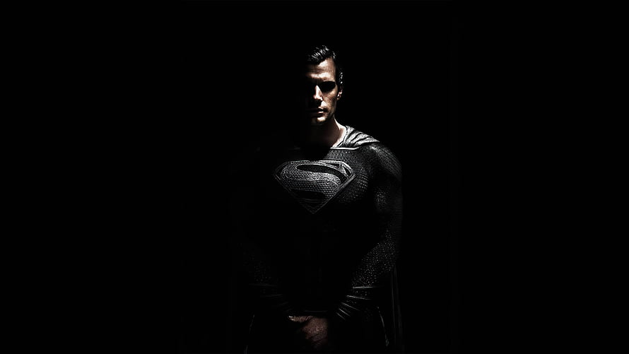 Superman in Dark Suit Emerging from Shadow with Dramatic Lighting HD wallpaper