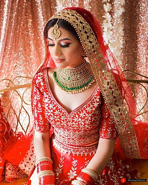 Elegant Indian Bride in Red Lehenga with Gold Jewelry and Embroidered Dupatta HD phone wallpaper