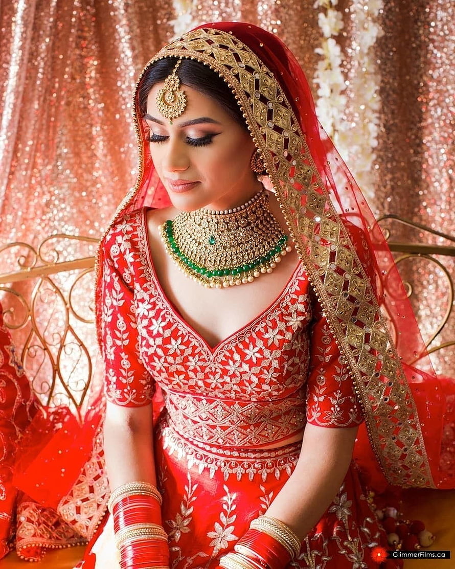 Elegant Indian Bride in Red Lehenga with Gold Jewelry and Embroidered Dupatta HD phone wallpaper