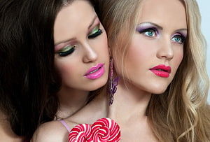 Close-up beauty portrait of two women with bold colorful makeup and glossy pink lips HD wallpaper