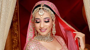 Nikeet Dhillon in Traditional Indian Bridal Attire with Pink Lehenga and Gold Jewelry HD wallpaper