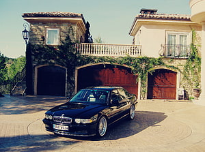 Black BMW E38 740i Sedan Parked in Front of a Mediterranean Villa HD wallpaper