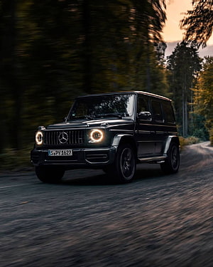 Black Mercedes G-Class SUV Driving on a Forest Road at Dusk HD phone wallpaper