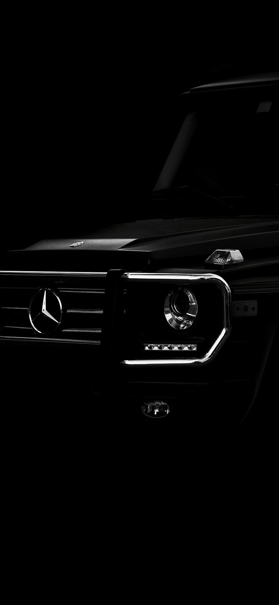 Mercedes-AMG G63 Front Grille and Headlight Close-Up in Dark Studio Lighting HD phone wallpaper