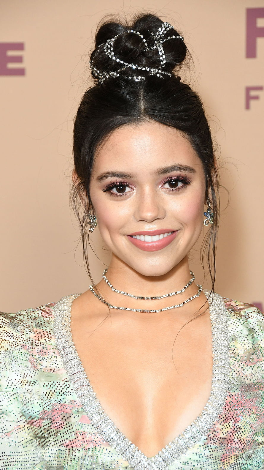 Jenna Ortega in an elegant updo with sparkling hair accessories and layered diamond necklaces at a red carpet event HD phone wallpaper