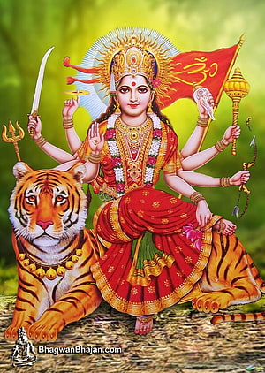 Maa Durga riding a tiger with multiple arms holding sacred weapons and a red flag HD phone wallpaper