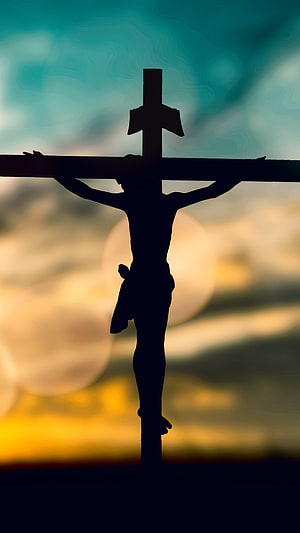 Silhouette of Jesus on the Cross Against a Golden Sunset Sky HD phone wallpaper