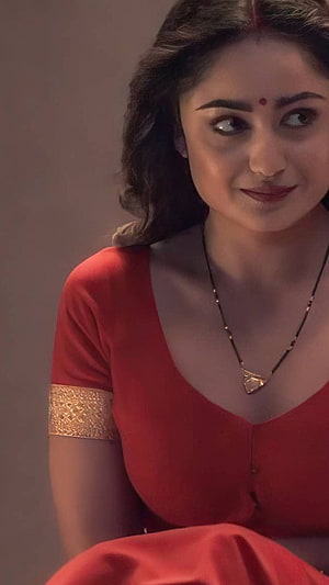 Tridha Choudhury in a red traditional outfit with gold trim and a delicate necklace HD phone wallpaper