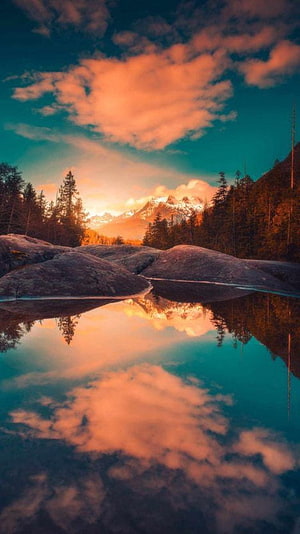 Alpine Lake Reflection at Sunset with Snow-Capped Mountains and Pine Forest HD phone wallpaper