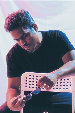 Yuvan Shankar Raja Portrait in Black T-Shirt Holding Sunglasses HD phone wallpaper