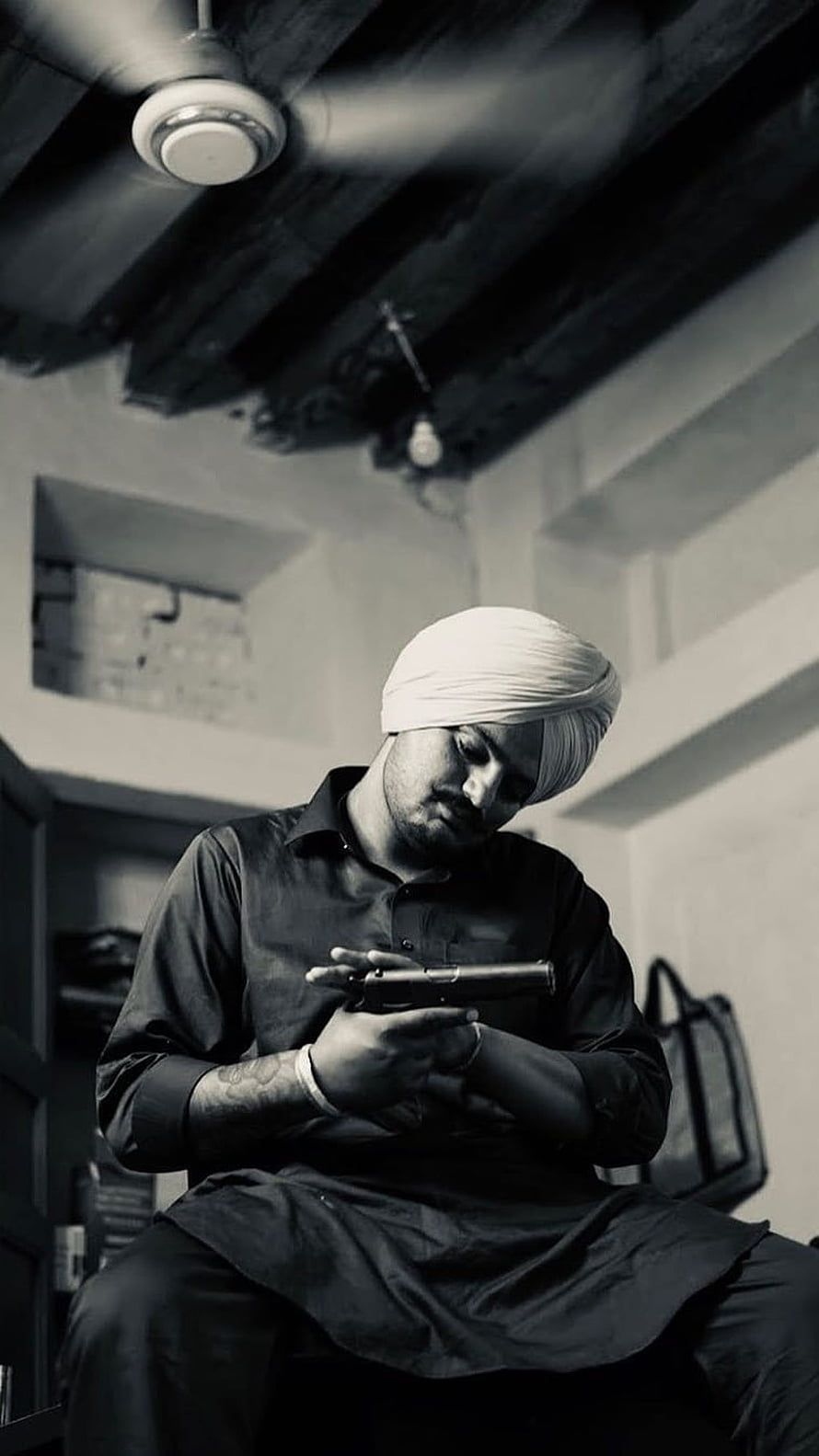 Sidhu Moose Wala in Black and White Portrait Wearing Turban and Holding a Pistol HD phone wallpaper