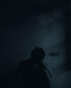 Silhouette of a person sitting alone in the rain with an arrow symbol on the wall HD phone wallpaper