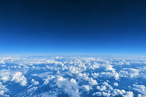 Aerial View of Endless Cloud Sea Beneath a Deep Blue Sky HD wallpaper