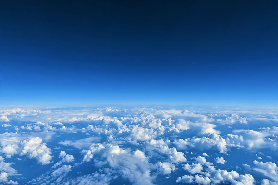 Aerial View of Endless Cloud Sea Beneath a Deep Blue Sky HD wallpaper