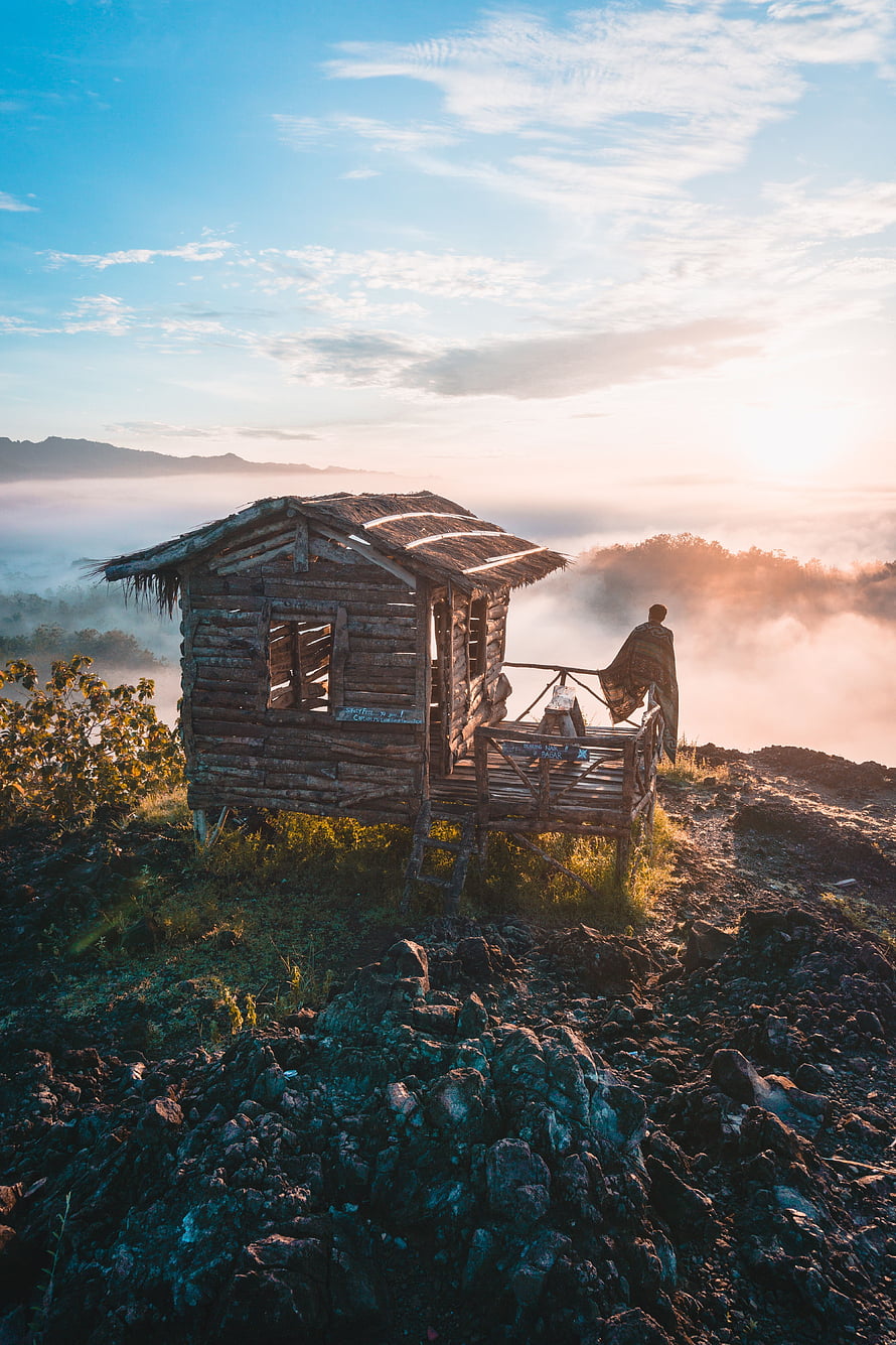 Rustic wooden hut on a misty mountain ridge at sunrise in Indonesia HD phone wallpaper