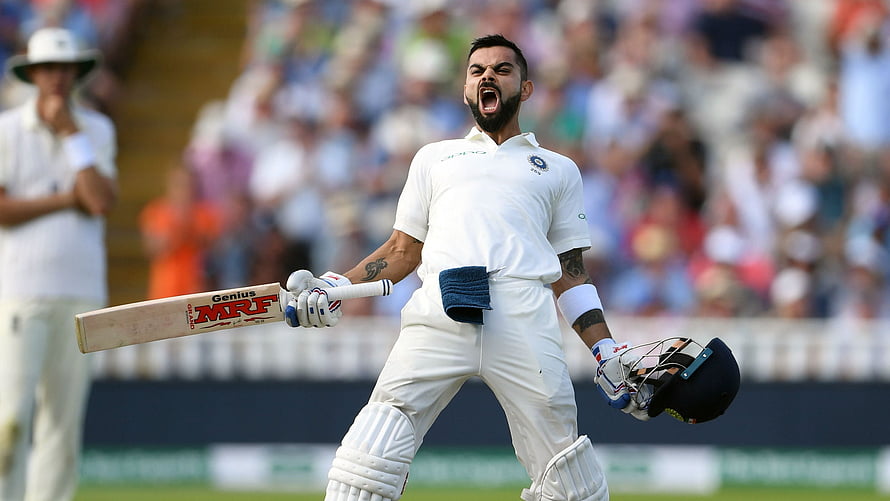Virat Kohli Celebrating a Test Match Milestone in White Cricket Gear HD wallpaper