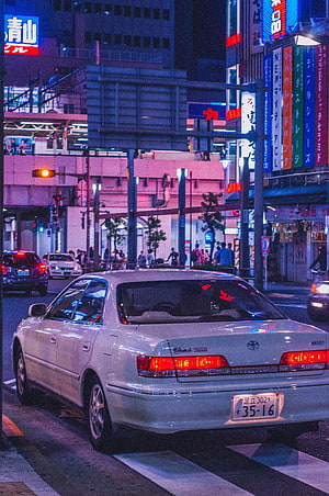White Toyota Chaser JDM Sedan on a Neon-Lit Tokyo Street at Night HD phone wallpaper