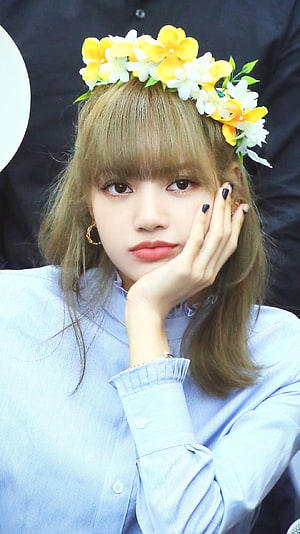 Lisa from BLACKPINK wearing a yellow and white flower crown with a light blue shirt HD phone wallpaper