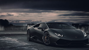 Matte Black Lamborghini Huracan Stance Under Dramatic Stormy Sky HD wallpaper