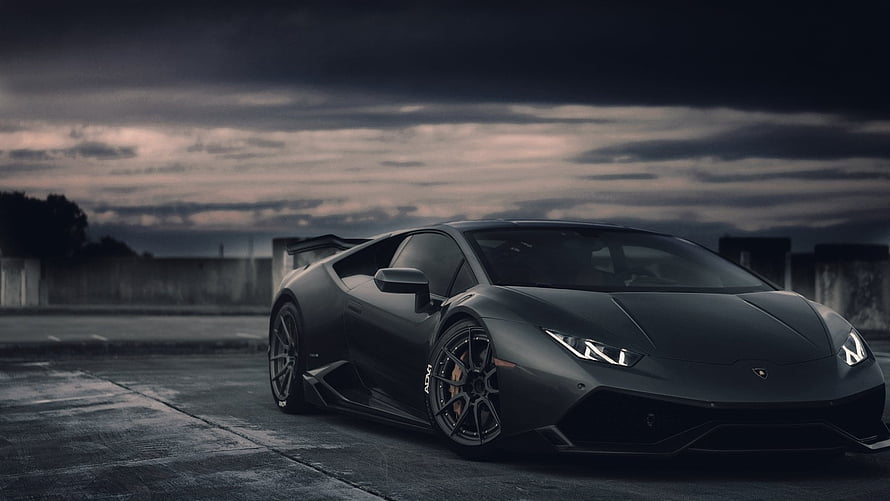 Matte Black Lamborghini Huracan Stance Under Dramatic Stormy Sky HD wallpaper