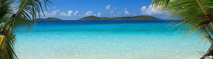 Tropical Island Lagoon with Turquoise Water and Palm Trees Framing a Distant Shoreline HD wallpaper
