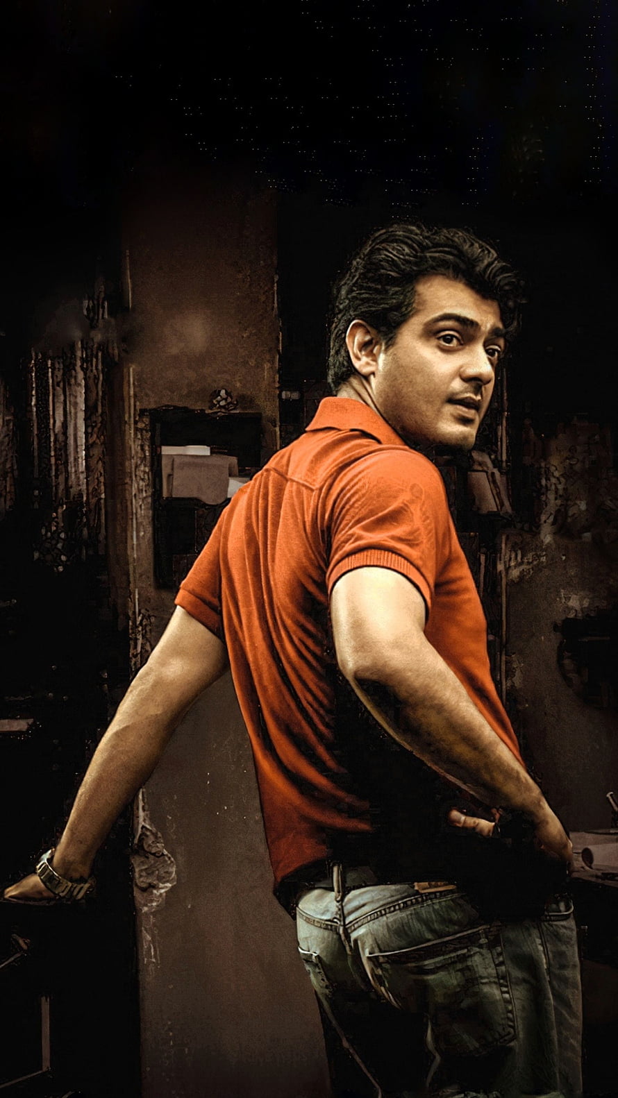 Ajith Kumar in an orange polo shirt standing in a dimly lit urban alleyway HD phone wallpaper