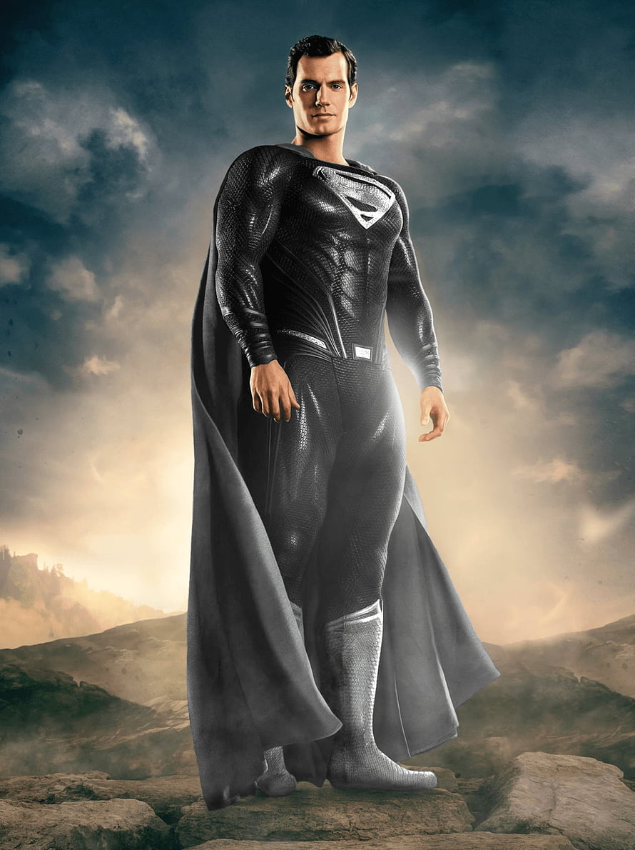 Superman in Black Suit Standing on Rocky Terrain Under Dramatic Sky HD phone wallpaper