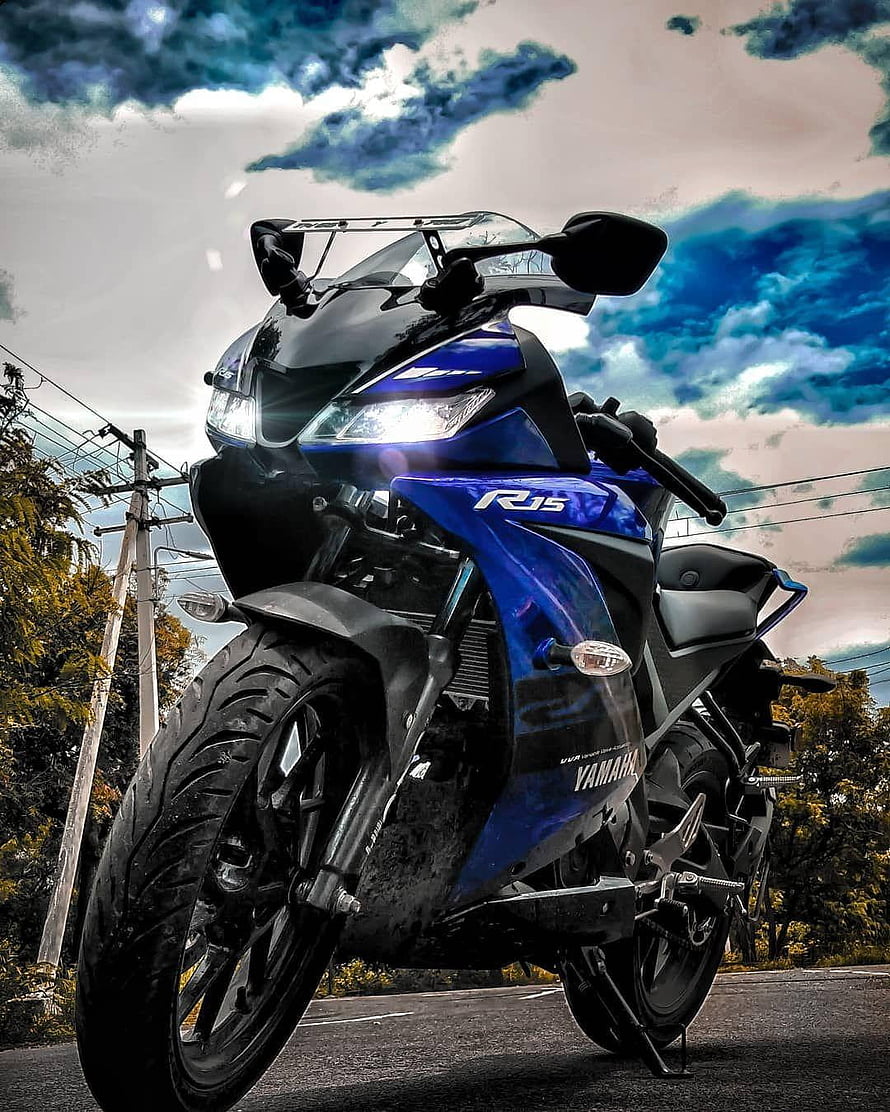Yamaha R15 V3 Blue Sport Motorcycle on Open Road Under Dramatic Sky HD phone wallpaper